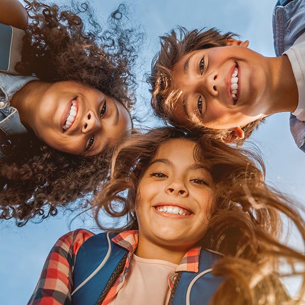 Three Children Looking Down at the Camera